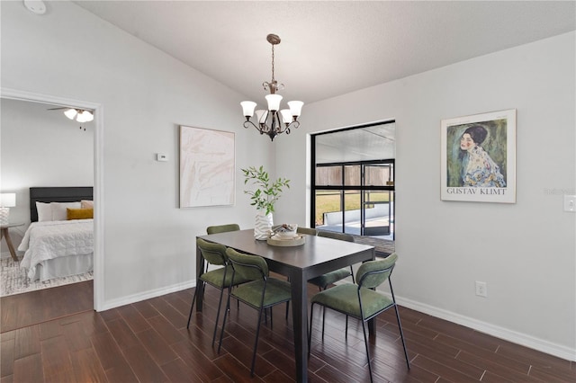 dining area featuring ceiling fan with notable chandelier, baseboards, and dark wood-style floors