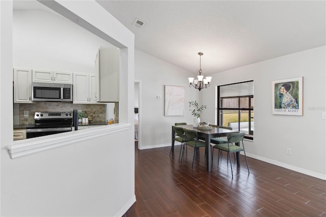dining room with baseboards, vaulted ceiling, a chandelier, dark wood-style floors, and visible vents