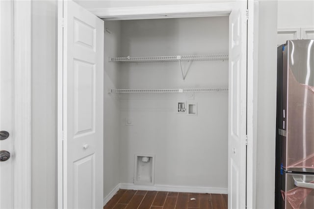 clothes washing area with dark wood-type flooring, laundry area, baseboards, and hookup for a washing machine