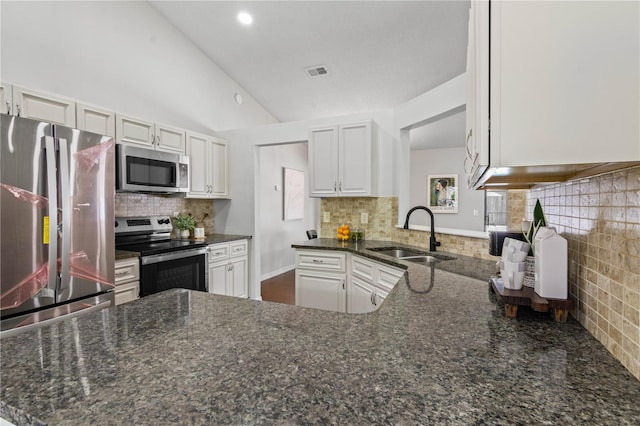 kitchen with stainless steel appliances, visible vents, a sink, and backsplash