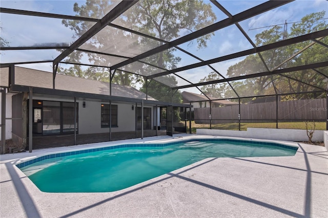 view of swimming pool featuring a lanai, a patio, a fenced in pool, and fence