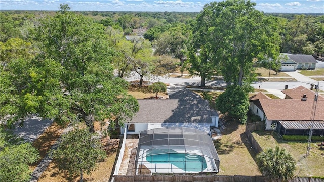 birds eye view of property featuring a wooded view
