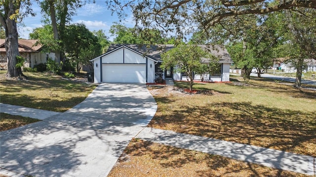 single story home featuring a front yard, an attached garage, and driveway
