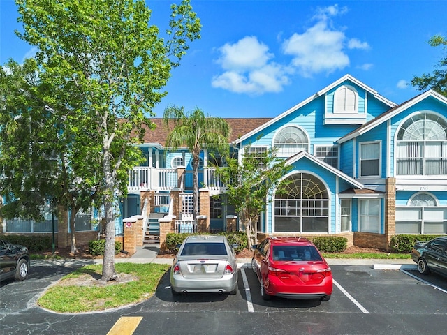 2745 N Poinciana Blvd Unit 65, Kissimmee, FL 34746 - view of property featuring stairs and uncovered parking