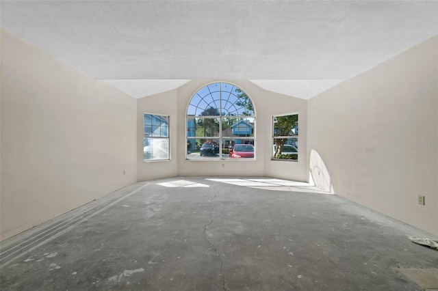 2745 N Poinciana Blvd Unit 65, Kissimmee, FL 34746 - unfurnished living room featuring lofted ceiling
