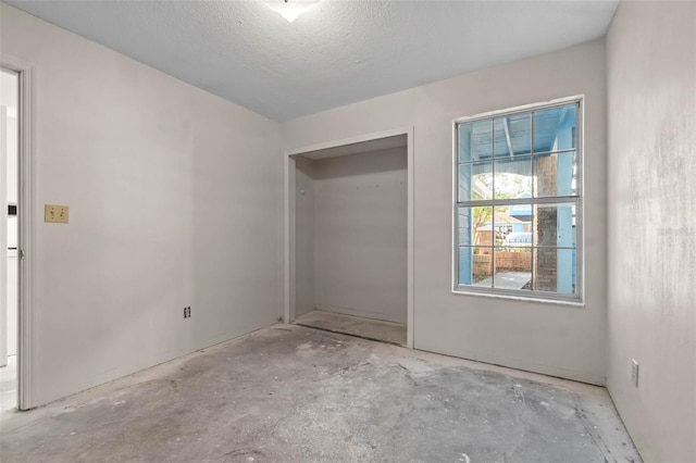 2745 N Poinciana Blvd Unit 65, Kissimmee, FL 34746 - unfurnished bedroom featuring concrete floors and a closet