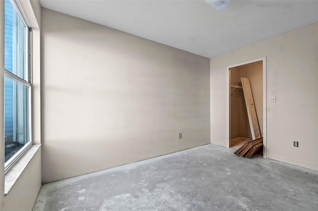 2745 N Poinciana Blvd Unit 65, Kissimmee, FL 34746 - unfurnished bedroom featuring multiple windows and unfinished concrete floors