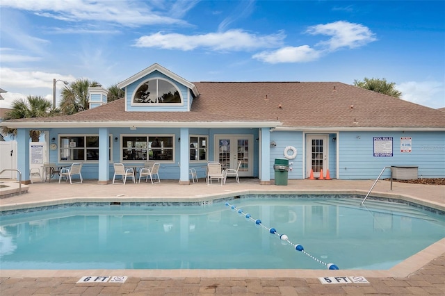 2745 N Poinciana Blvd Unit 65, Kissimmee, FL 34746 - back of house featuring a patio, french doors, a community pool, and a shingled roof
