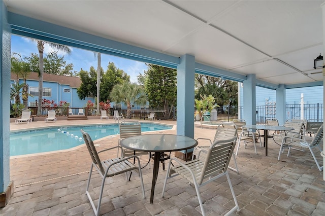 2745 N Poinciana Blvd Unit 65, Kissimmee, FL 34746 - community pool featuring a patio area and fence