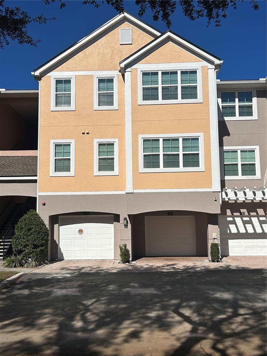 multi unit property featuring a garage and stucco siding