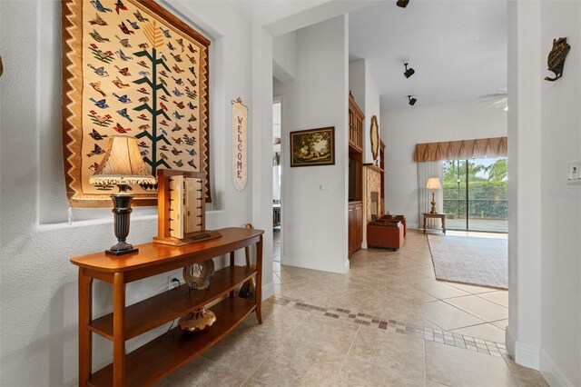 469 Sorrento Rd, Kissimmee, FL 34759 - hallway featuring light tile patterned floors and baseboards
