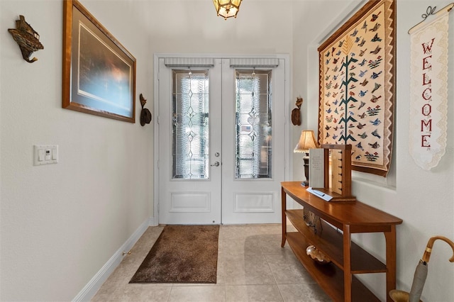 469 Sorrento Rd, Kissimmee, FL 34759 - foyer featuring french doors, light tile patterned flooring, and baseboards