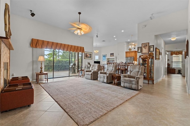 469 Sorrento Rd, Kissimmee, FL 34759 - living room featuring a wealth of natural light, light tile patterned flooring, and ceiling fan with notable chandelier