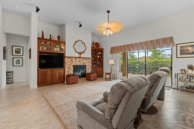469 Sorrento Rd, Kissimmee, FL 34759 - living area featuring light tile patterned floors, a ceiling fan, and a brick fireplace