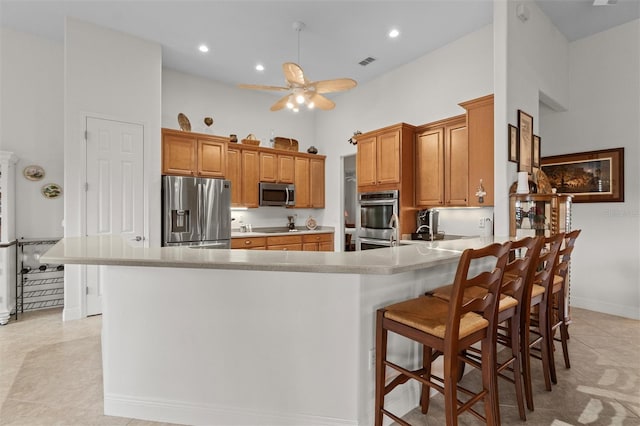 469 Sorrento Rd, Kissimmee, FL 34759 - kitchen featuring a peninsula, a ceiling fan, visible vents, stainless steel appliances, and baseboards