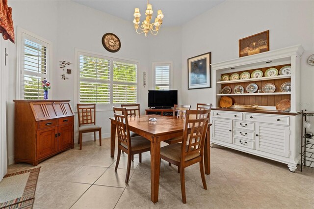 469 Sorrento Rd, Kissimmee, FL 34759 - dining room with light tile patterned flooring, an inviting chandelier, and baseboards