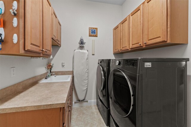 469 Sorrento Rd, Kissimmee, FL 34759 - laundry area with baseboards, a sink, washing machine and clothes dryer, and cabinet space