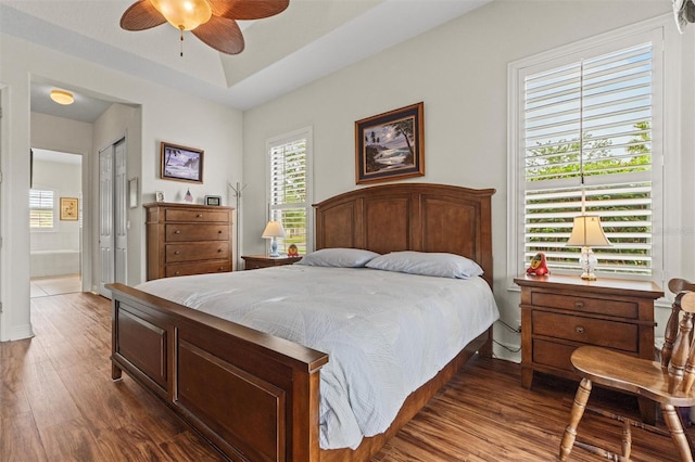 469 Sorrento Rd, Kissimmee, FL 34759 - bedroom with ceiling fan, multiple windows, connected bathroom, and wood finished floors