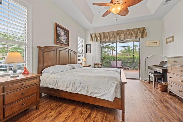 469 Sorrento Rd, Kissimmee, FL 34759 - bedroom featuring visible vents, a raised ceiling, ceiling fan, wood finished floors, and access to exterior