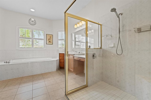 469 Sorrento Rd, Kissimmee, FL 34759 - bathroom featuring a bath, tile patterned flooring, a tile shower, and vanity