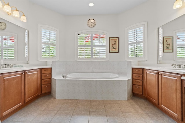 469 Sorrento Rd, Kissimmee, FL 34759 - full bath with a garden tub, two vanities, a sink, and tile patterned flooring