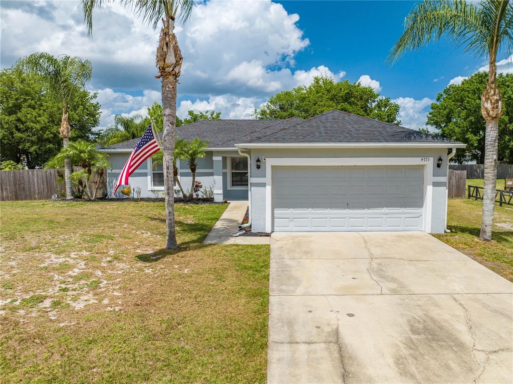 single story home featuring a garage, stucco siding, and a front yard
