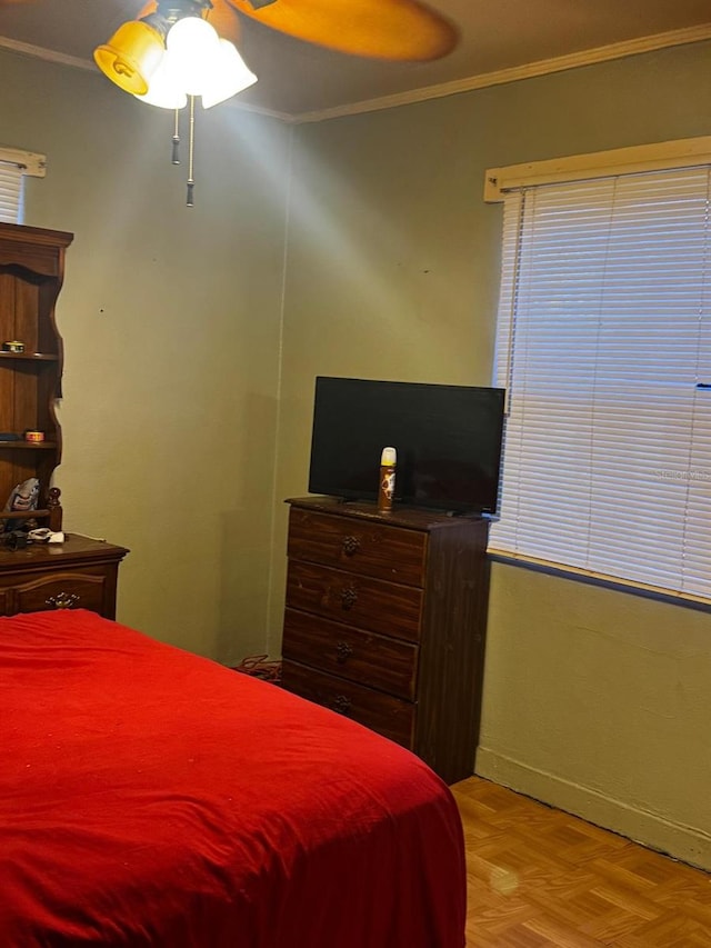 bedroom with a ceiling fan, baseboards, and ornamental molding