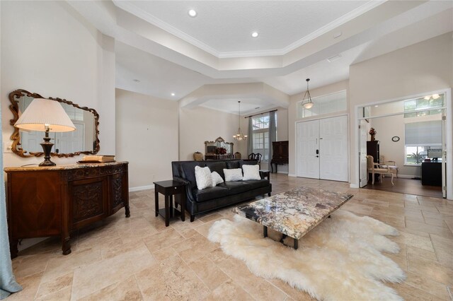 9509 Baycliff Ct, Orlando, FL 32836 - living area with stone tile flooring, recessed lighting, crown molding, a tray ceiling, and a chandelier