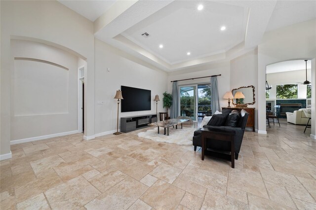 9509 Baycliff Ct, Orlando, FL 32836 - living area with stone tile flooring, plenty of natural light, a raised ceiling, baseboards, and recessed lighting