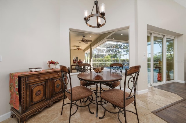 9509 Baycliff Ct, Orlando, FL 32836 - dining space featuring a chandelier, healthy amount of natural light, baseboards, and a high ceiling