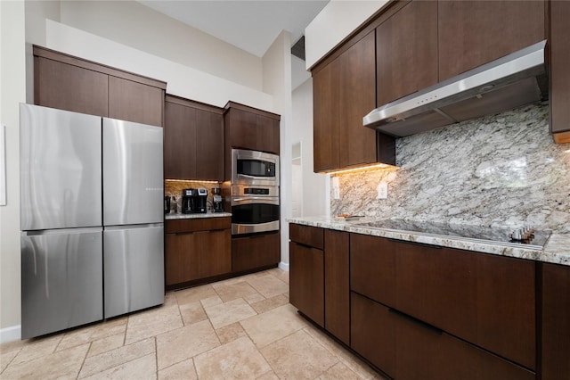 9509 Baycliff Ct, Orlando, FL 32836 - kitchen featuring appliances with stainless steel finishes, under cabinet range hood, backsplash, dark brown cabinetry, and baseboards