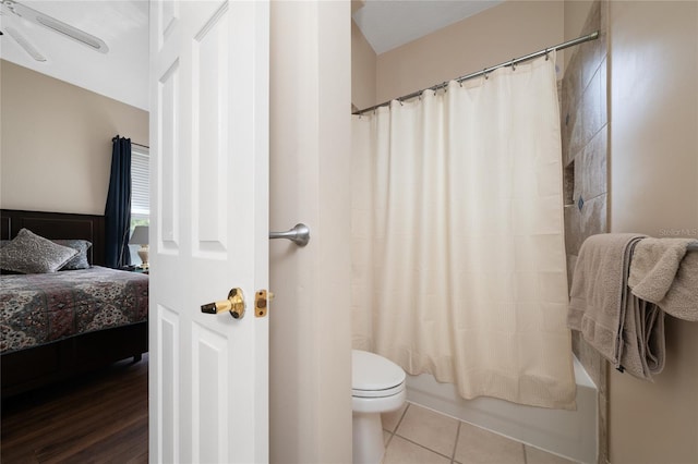 9509 Baycliff Ct, Orlando, FL 32836 - ensuite bathroom with toilet, ceiling fan, tile patterned floors, and shower / tub combo with curtain