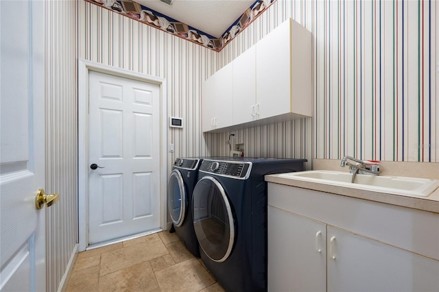 9509 Baycliff Ct, Orlando, FL 32836 - laundry area featuring cabinet space, washer and dryer, wallpapered walls, light stone finish flooring, and baseboards
