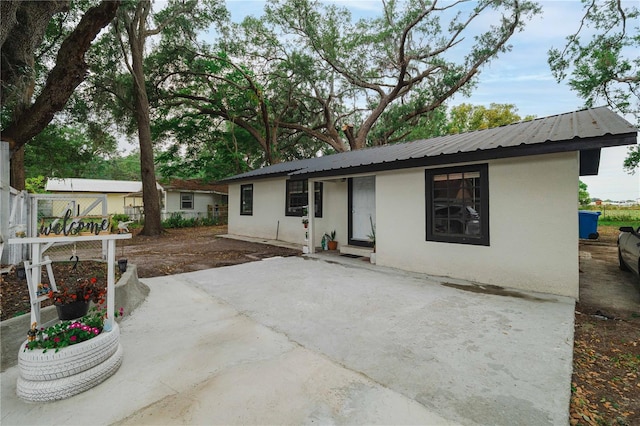 2804 Robinson Rd, Plant City, FL 33565 - view of front of property with a patio, metal roof, stucco siding, and fence