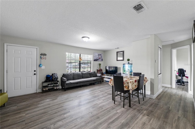 2804 Robinson Rd, Plant City, FL 33565 - dining area with visible vents, wood finished floors, and a textured ceiling