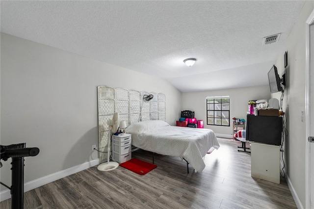 2804 Robinson Rd, Plant City, FL 33565 - bedroom featuring visible vents, baseboards, a textured ceiling, and wood finished floors