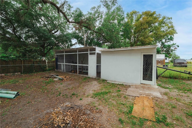 2804 Robinson Rd, Plant City, FL 33565 - back of house with fence, metal roof, and stucco siding