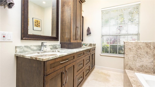 2734 Eagle Lake Dr, Orlando, FL 32837 - bathroom featuring a sink, a bath, double vanity, baseboards, and tile patterned flooring