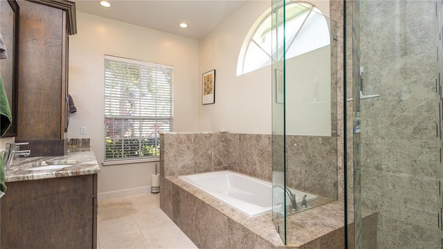 2734 Eagle Lake Dr, Orlando, FL 32837 - bathroom with tile patterned floors, baseboards, recessed lighting, a garden tub, and vanity