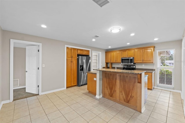 14010 102nd Ave, Largo, FL 33774 - kitchen with stainless steel appliances, light tile patterned floors, visible vents, and baseboards