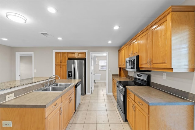 14010 102nd Ave, Largo, FL 33774 - kitchen with baseboards, recessed lighting, light tile patterned flooring, appliances with stainless steel finishes, and a sink