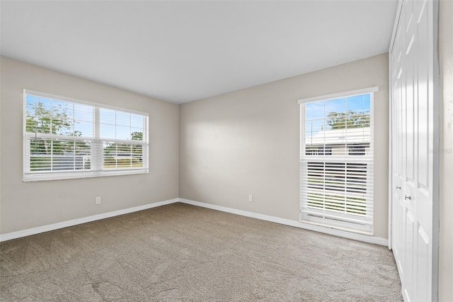 14010 102nd Ave, Largo, FL 33774 - carpeted spare room with baseboards and a healthy amount of sunlight