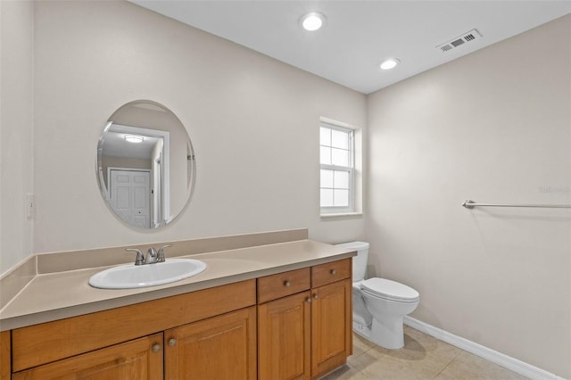14010 102nd Ave, Largo, FL 33774 - bathroom with vanity, baseboards, tile patterned floors, toilet, and visible vents