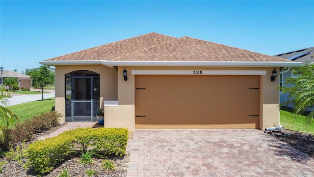 328 Vestrella Dr, Poinciana, FL 34759 - view of front facade featuring an attached garage, a shingled roof, stucco siding, and driveway