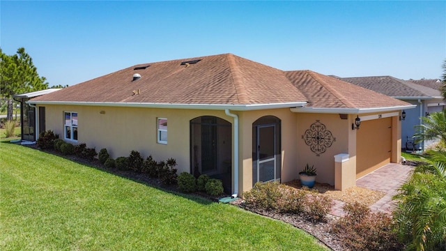 328 Vestrella Dr, Poinciana, FL 34759 - back of property with a lawn, a shingled roof, stucco siding, and an attached garage