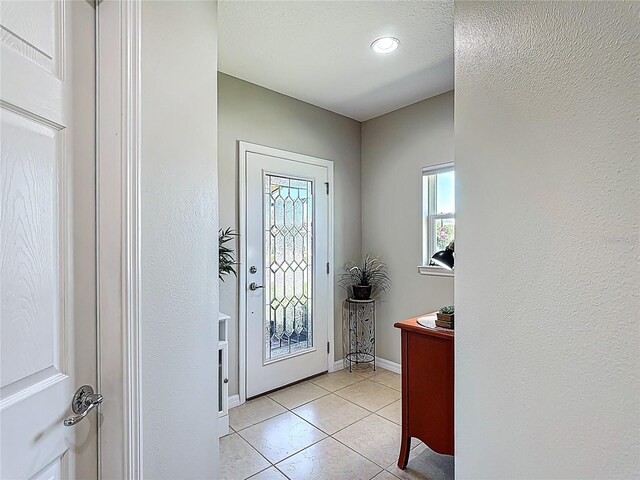 328 Vestrella Dr, Poinciana, FL 34759 - foyer entrance with plenty of natural light, light tile patterned floors, and baseboards
