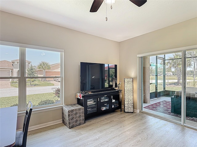 328 Vestrella Dr, Poinciana, FL 34759 - living area with ceiling fan, baseboards, wood finished floors, and a healthy amount of sunlight