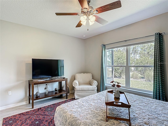 328 Vestrella Dr, Poinciana, FL 34759 - bedroom featuring baseboards, a ceiling fan, wood finished floors, and a textured ceiling