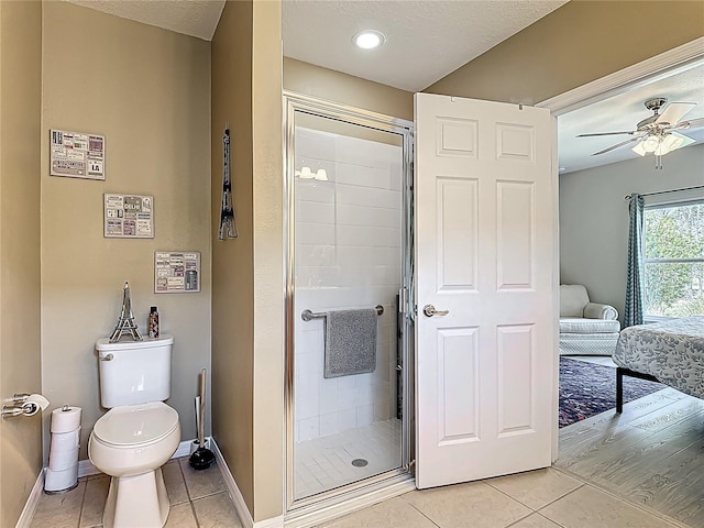 328 Vestrella Dr, Poinciana, FL 34759 - full bath with baseboards, tile patterned floors, a ceiling fan, toilet, and a shower stall