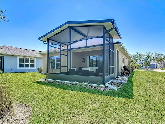 328 Vestrella Dr, Poinciana, FL 34759 - rear view of house featuring stucco siding, a sunroom, and a lawn